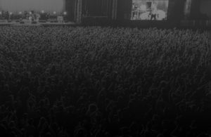 Black and white photo of the crowd for the ''about us'' section