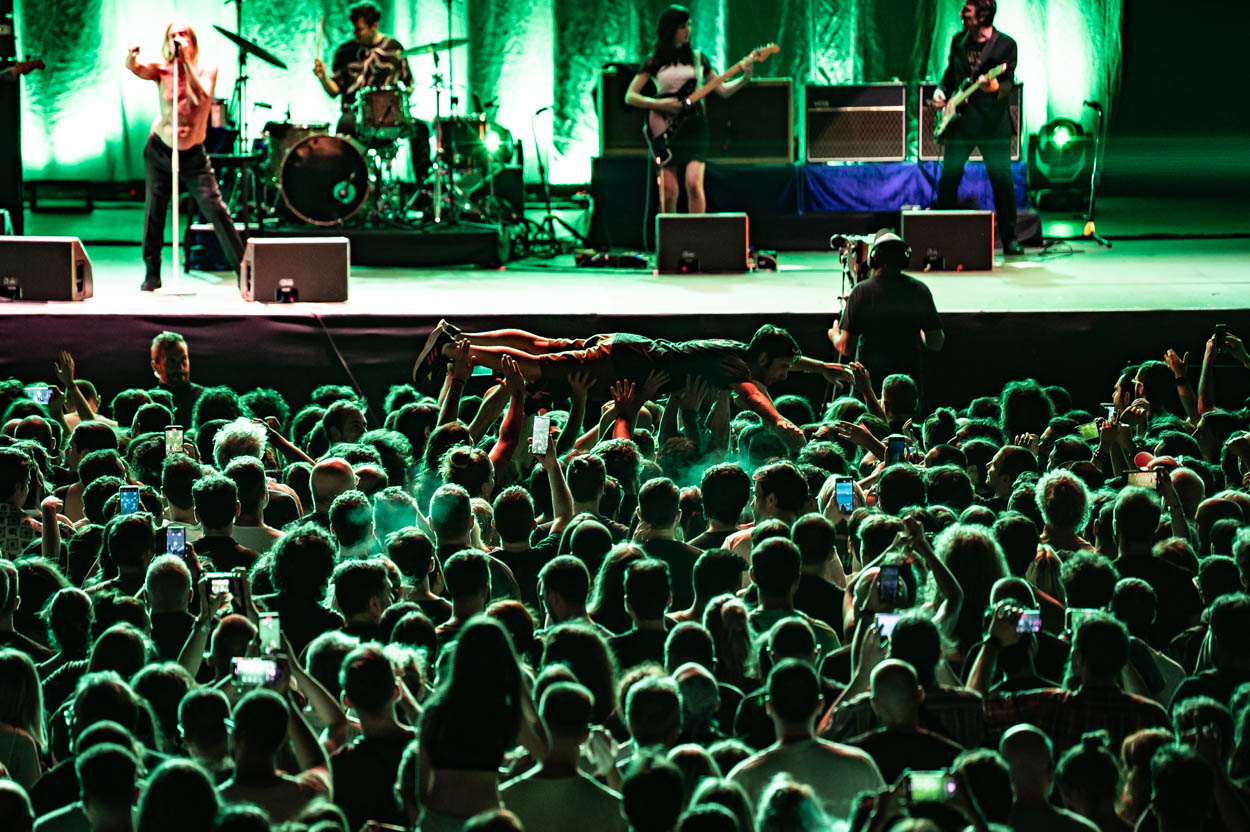 Photo of the audience (crowd-surfing) & Iggy Pop while performing at Release Athens 2022